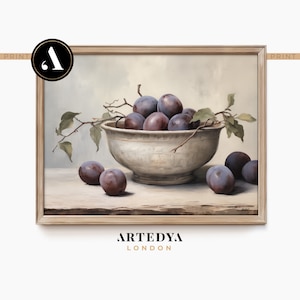 May include: A white ceramic bowl filled with purple plums, with some plums spilling out of the bowl and onto a wooden surface. The bowl has a decorative design and is surrounded by green leaves.