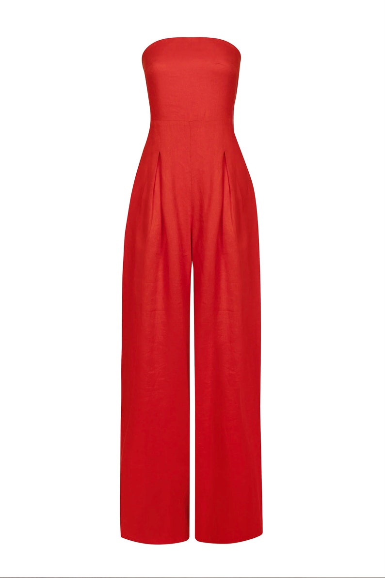 May include: A strapless red jumpsuit with wide legs and a relaxed fit.