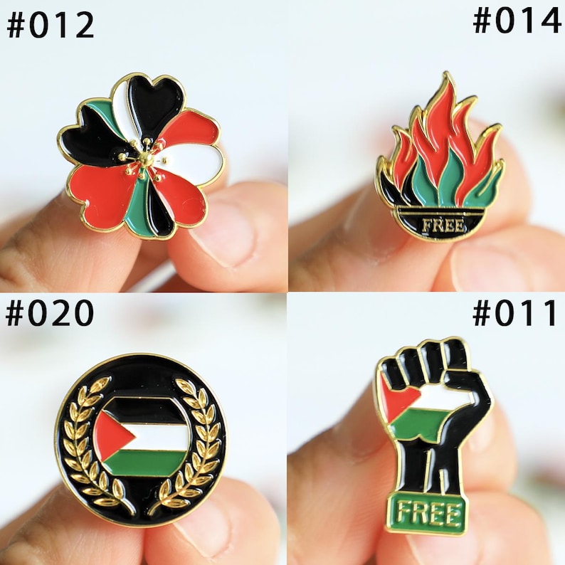 May include: A collection of four enamel pins with gold-colored borders. The pins feature various designs, including a flower, flames, a wreath with a flag, and a raised fist. Each pin has the word "FREE" on it.