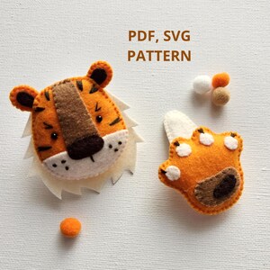 May include: A felt tiger head and paw pattern in PDF and SVG format. The pattern includes a tiger head with orange and brown fur, white eyes, and a black nose. The paw is orange with brown details and white spots.