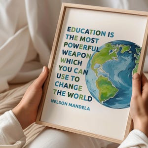May include: A framed print with a quote by Nelson Mandela about education being the most powerful weapon to change the world. The quote is printed in colorful text against a white background, with a colorful illustration of the Earth in the background.