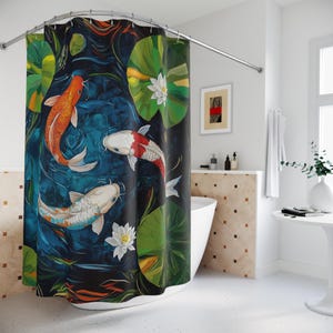 May include: A shower curtain with a blue background featuring three colorful koi fish swimming in a pond with lily pads and white flowers.