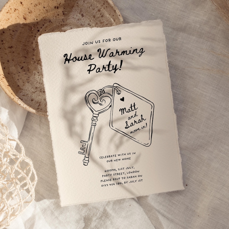 May include: A housewarming party invitation with a black and white illustration of a key and a tag that says "Matt and Sarah move in!" The invitation is on a cream-colored paper background.