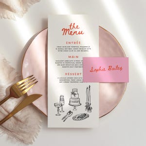 May include: A wedding menu with the text "the Menu" in red script. The menu includes Entrée, Main, and Dessert options. A pink place card with the name "Sophie Bailey" is also present, along with a gold fork and knife.
