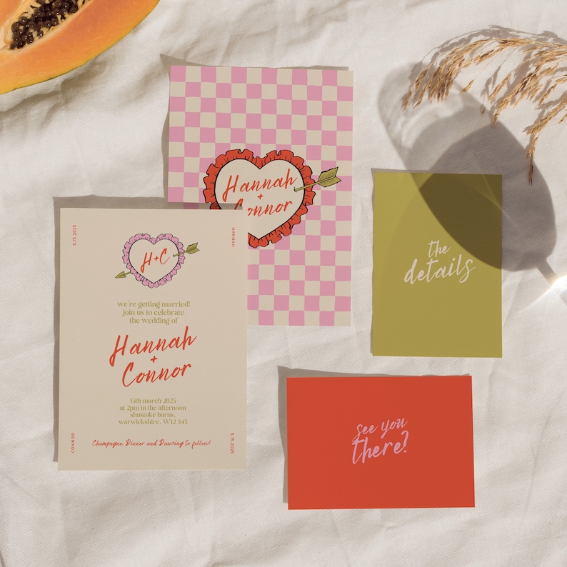 May include: Wedding invitation with a pink and white checkered background, a red heart with the text "Hannah + Connor" and the text "the details" on a green card. The invitation text reads "we're getting married! join us to celebrate the wedding of Hannah + Connor 13th March 2025 at 2pm in the afternoon Suntukes Warwickshire, WV12 543 Champagne, Dinner and Dancing to follow!"