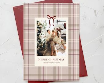 May include: Christmas card with a family photo inside a plaid pattern. The card has a red envelope. The photo shows a family with a Christmas tree. The text on the card reads "MERRY CHRISTMAS Love from the Smith's".