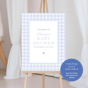 May include: A blue and white gingham baby shower welcome sign with the text "Welcome to Laurens Baby Shower September 12th 2024". A small blue heart is in the bottom center of the sign. A blue circle with the text "matching items AVAILABLE See the listing description for details!" is in the bottom right corner of the image.