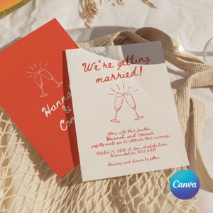 May include: A wedding invitation with a red background and white text. The text reads "We're getting married!" and includes the names Hannah and Connor, the date and time of the wedding, and the location. The invitation also features a simple illustration of two champagne glasses.