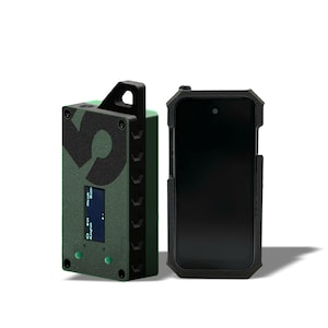 May include: Two electronic devices. One is a rectangular, olive green device with a black handle, a screen, and the number "9" in black. The other is a black smartphone in a protective case.