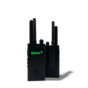 May include: Two black walkie-talkies with antennas, standing upright against a white background. The text "spec5" is printed in green on the front of the left walkie-talkie. The walkie-talkies have a clip on the back.