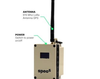 May include: A beige and black spec5 device with a black antenna, a power switch, and a small screen. The text "spec5" is printed on the front of the device.