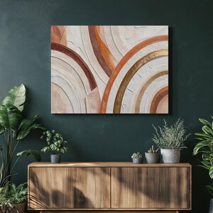 Könnte beinhalten: Abstrakte Wandkunst mit strukturierten, geschichteten Bögen in Beige-, Braun- und Goldtönen. Das Kunstwerk ist an einer dunkelgrünen Wand angebracht, was einen starken Kontrast erzeugt. Ein moderner Akzent für jeden Raum.