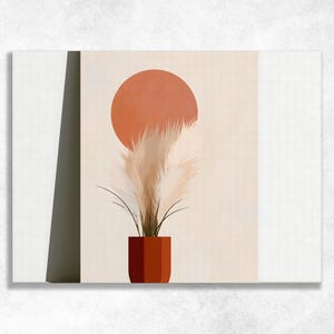 Puede incluir: Una impresión de arte mural rectangular que presenta una forma circular de color terracota colocada sobre un grupo de tallos de hierba de la pampa beige. Los tallos están contenidos en una maceta cilíndrica de color terracota sobre un fondo crema.