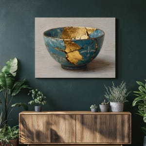 May include: A teal ceramic bowl with gold-filled cracks, showcasing the Japanese art of Kintsugi. The bowl is set against a neutral background, highlighting the contrast between the teal and gold. The artwork is displayed on a wall.