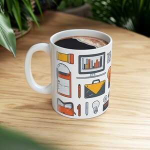 May include: White ceramic mug filled with dark coffee, featuring a repeating pattern of office-related icons in orange, yellow, and gray. The icons include a computer monitor, briefcase, lightbulb, and pen.