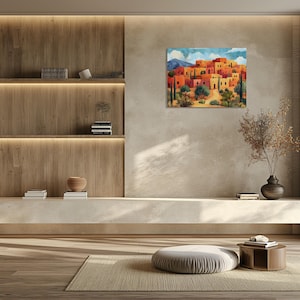 Rustic adobe houses and tall desert shrubs framed by distant mountains and soft clouds.