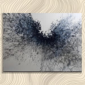 May include: Abstract art print featuring a central explosion of dark blue and black hues against a light gray background. The artwork has a cracked, textured appearance, with fine lines radiating outwards.