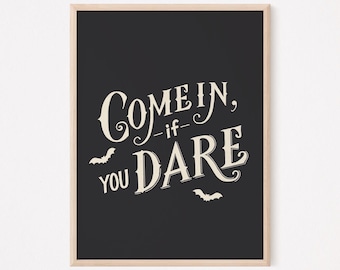 May include: Black and white printable Halloween sign with the text "Come in, -if- you dare" and two bats.