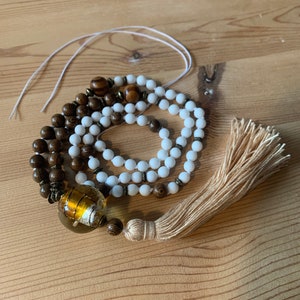 a special Black Forest glass bead brings together the nuances between cotton tassel + wooden beads Unique long necklace Smooth round beads