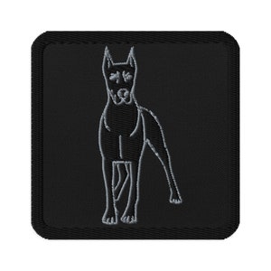 May include: Embroidered patch featuring a Great Dane dog in a minimalist, line-art style. The dog is depicted in white thread against a black square background. The patch has a stitched border.