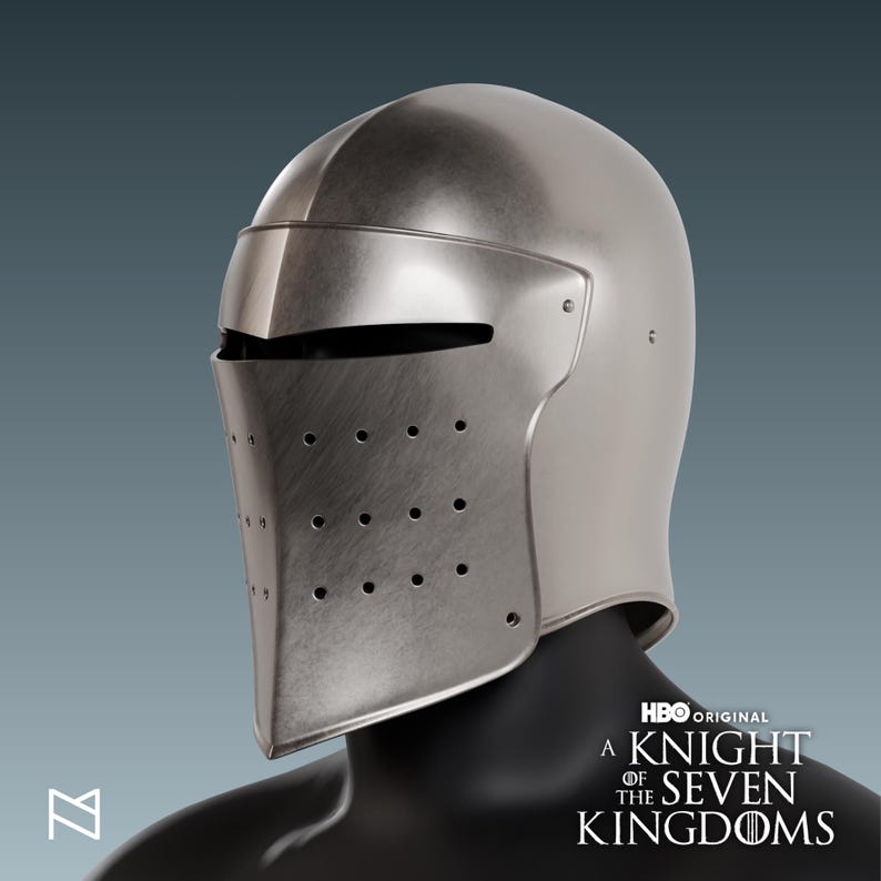 May include: A silver-colored medieval helmet with a visor and numerous small ventilation holes. The helmet is part of a costume and is displayed on a black mannequin head. The HBO Original logo and the text "A Knight of the Seven Kingdoms" are visible.