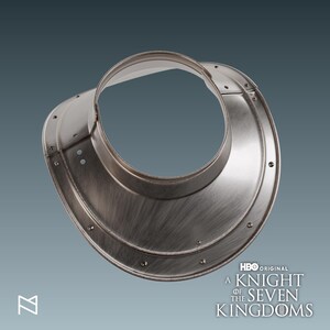 May include: A silver-colored gorget, a piece of medieval armor, with a circular neck opening and a flared lower edge. The armor is riveted and has a brushed metal texture. The HBO Original logo and "A Knight of the Seven Kingdoms" text are visible.