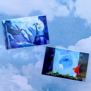 May include: Two illustrated postcards with a blue and white mountain scene and a blue sky with a white bird flying above a dark green forest.