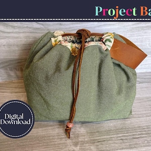 May include: An olive green project bag with a floral patterned trim and a brown leather tag. The bag is cinched closed with a brown drawstring. The words "Project Bag" are at the top of the image, and "Digital Download" is in a circle at the bottom.