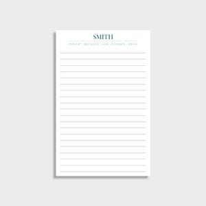 May include: A white notepad with horizontal gray lines. The word "SMITH" is printed in teal at the top, with the names "PHILLIP • BETHANY • SAM • LINDSEY • REESE" below it. The notepad is rectangular and sits on a white surface.