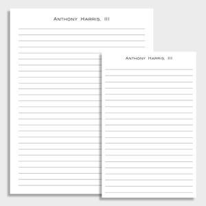 May include: Two lined notepads, one large and one small, are displayed. The text "ANTHONY HARRIS, III" is printed at the top of each page in a simple, sans-serif font. The pages are white with horizontal gray lines.