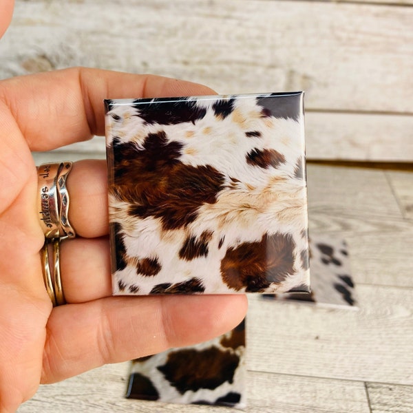 Cow Hide Print Magnets, four unique images on 2 inch magnets. Perfect for displaying photos or organizing notes.