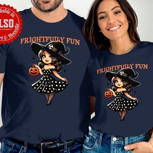 May include: Navy blue t-shirts featuring a cartoon witch holding a jack-o'-lantern. The witch wears a black hat and a polka dot dress. The text "FRIGHTFULLY FUN" is printed above the witch. Available in sweatshirt and hoodie.
