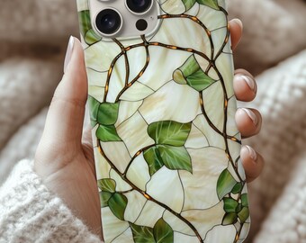 May include: A phone case featuring a stained glass design with green ivy leaves and vines on a cream-colored background. The case has a glossy finish and a camera cutout.