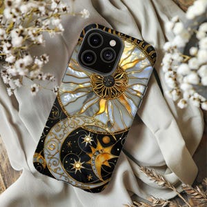 May include: A black and gold celestial-themed phone case featuring a sun, moon, and stars design. The case has a pearlescent background with gold accents and a black border. The phone case is designed to fit a smartphone.