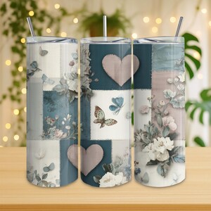 May include: Three stainless steel insulated tumblers with lids and straws. The tumblers feature a patchwork design with butterflies, flowers, and hearts in shades of blue, white, and beige. The design is printed on the exterior of the tumblers.