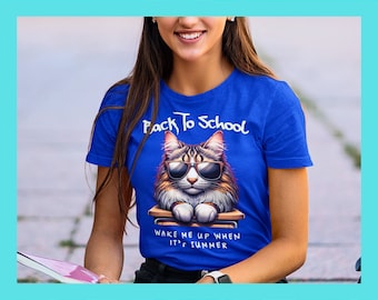 May include: A blue t-shirt with a cartoon cat wearing sunglasses and sitting on a stack of books. The text on the shirt reads "Back To School" and "Wake Me Up When It's Summer".