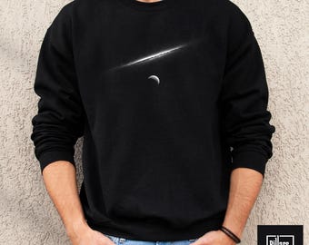 May include: Black crew neck sweatshirt with a white graphic of a celestial scene, including a bright streak and a crescent moon. The word "Black" is in a black rectangle in the upper left corner. The Pillars of Craft logo is in the lower right corner.