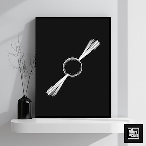 May include: Black framed art print featuring a white abstract design of a sphere with radiating lines. The artwork is displayed on a white shelf with a black vase and decorative branches. The print is from Pillars of Craft.