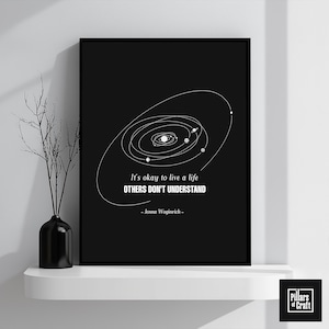 May include: Black and white printable wall art featuring a stylized solar system with the quote "It's okay to live a life others don't understand - Jenna Woginrich -"