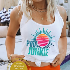 May include: White tank top with a graphic of a sun with a retro sunset design and the text "POOL JUNKIE" in turquoise blue.