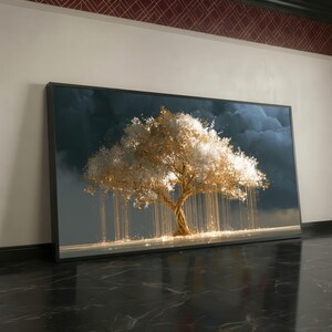 May include: A rectangular wall art print featuring a large tree with a golden trunk and branches, adorned with glowing white and gold foliage. Long, thin golden light strands hang from the branches against a dark, stormy, cloud-filled sky.