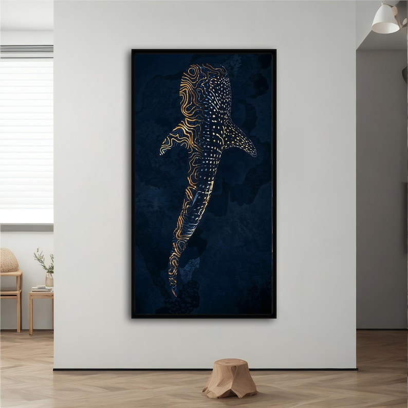 May include: An abstract illustration of a whale shark swimming in a dark blue ocean. The shark's body is outlined in gold and has a pattern of dots and lines.
