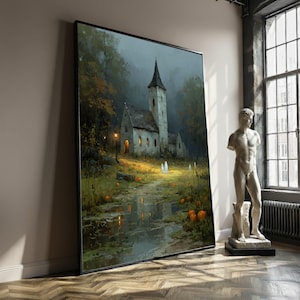 May include: Large framed artwork showing a church in a misty forest. The painting features a path leading to the church, with pumpkins and soft lighting. The artwork is leaning against a wall in a room with a statue.