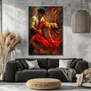 May include: A painting of a couple dancing. The man is wearing a black hat and a white shirt. The woman is wearing a red dress. The background is a colorful abstract design.