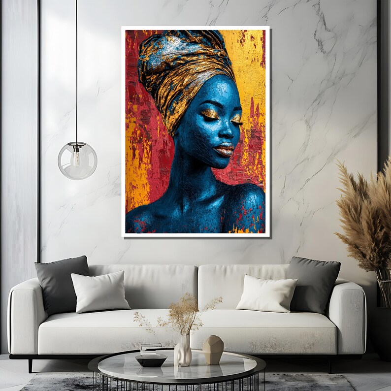 May include: A framed portrait of a woman with blue skin and gold eye makeup, wearing a gold head wrap. The background features red and yellow textured paint strokes. The artwork is displayed above a white sofa.