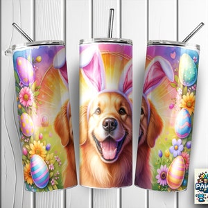 May include: A golden retriever dog wearing pink bunny ears with a colorful Easter egg design on a white tumbler. The tumbler has a straw and is surrounded by flowers and Easter eggs.