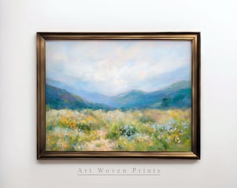 May include: A framed painting of a landscape with a field of wildflowers in the foreground and a mountain range in the background. The sky is a light blue with white clouds. The painting is in a gold frame.