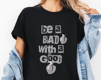 Gifted Badass Funny Peach Graphic Tee, Be Bad with a Good Shirt, Unisex Graphic T-Shirt, Retro Typography Top, Playful Bold Text Shirt