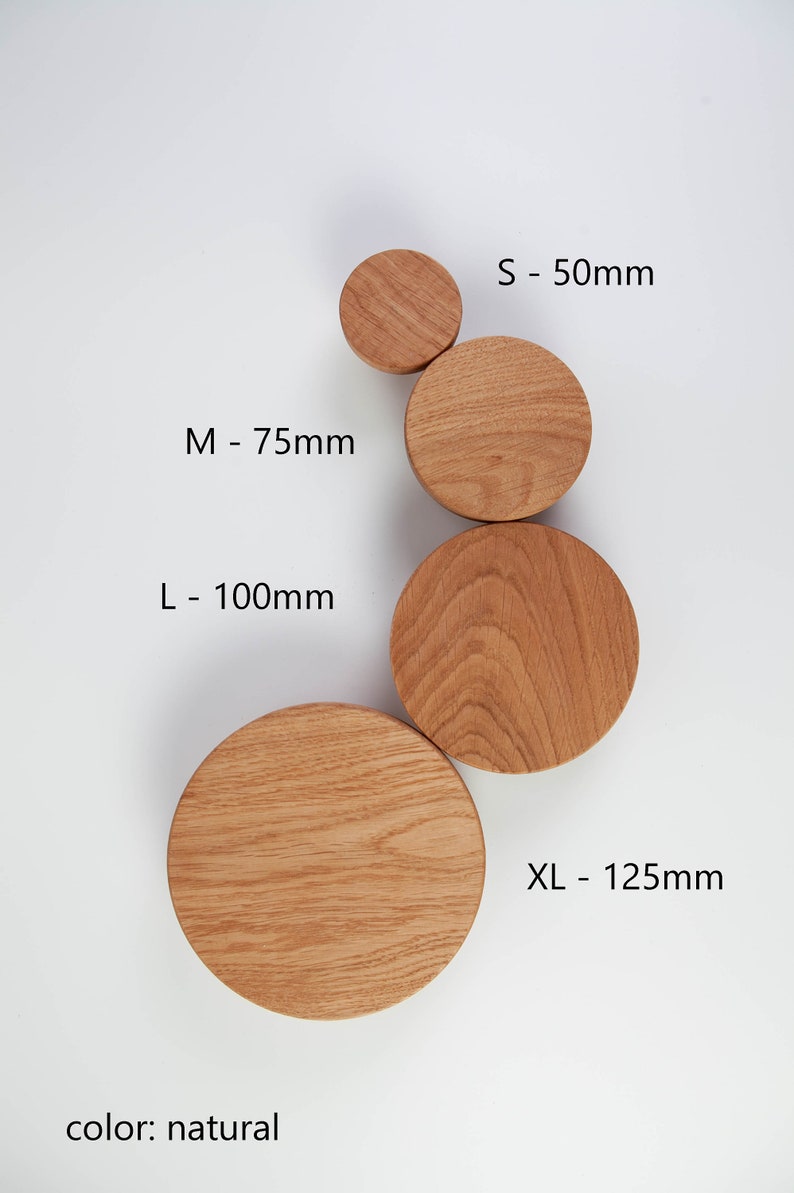 May include: Four wooden wall hooks in different sizes: small (50mm), medium (75mm), large (100mm), and extra large (125mm). The hooks are natural wood color.