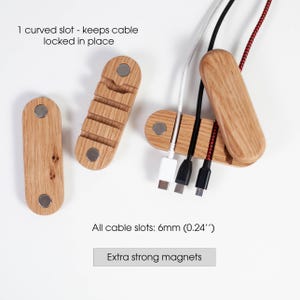 May include: Wooden cable organizers with strong magnets. The organizers have slots to hold cables in place. The text on the image says "1 curved slot - keeps cable locked in place" and "All cable slots: 6mm (0.24")".